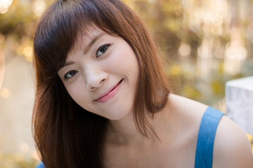 Close up of young pretty Asian woman in the garden.