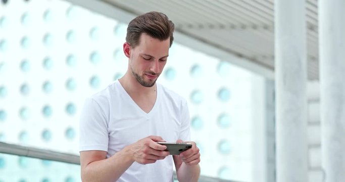 Young man play game on mobile phone