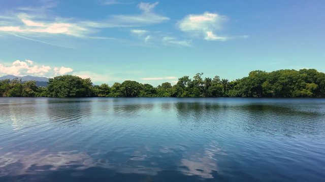View of a placid lake located in Tela, Honduras shot on a sunny day in the afternoon.