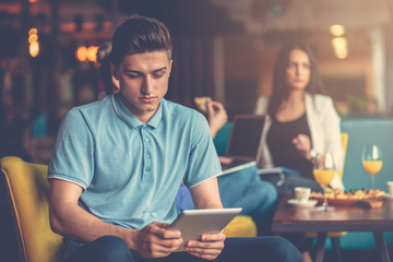 Young male using digital tablet in modern startup office