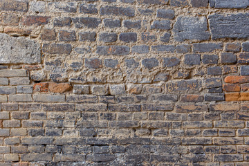 Ancient brick wall with different brick size.