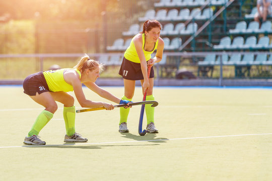 Two young field hockey player girls waiting for penalty shot