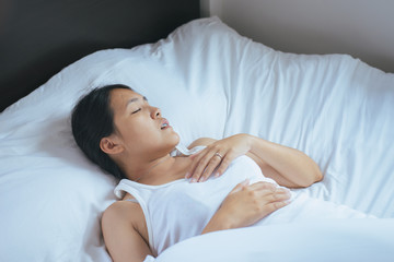 Asian woman snoring because due to tired of work,Female snor while sleeping in bedroom