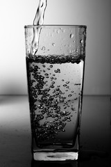 Water pouring into the clear glass