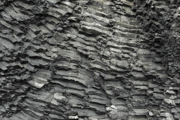 The texture of the basalt stone on the Black Beach in Iceland