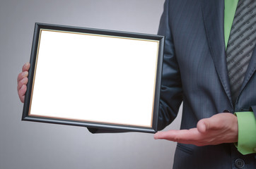 Blank diploma or certificate mock up in businessman hand. Empty photo frame border with copy space.