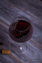 glass of red wine on wooden table