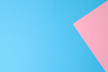 Blue and pink papers geometric lay down as a background.