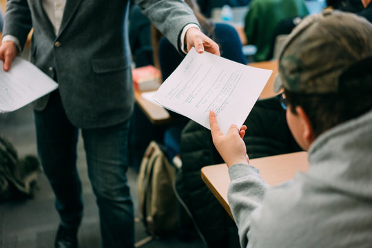 student receives paper from professor
