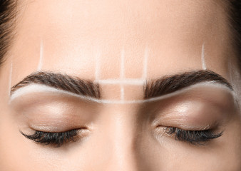 Young woman before procedure of eyebrows permanent makeup, closeup
