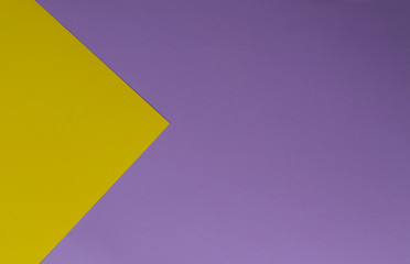 Yellow and purple papers geometric lay down as a background.