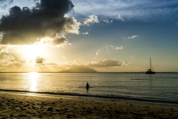 woman at sunset seychelles beach beau vallon 