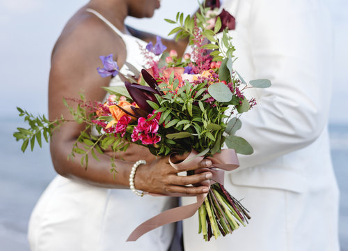 African American couple getting married at the beach