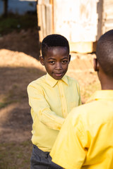 Black boy looking straight into the camera.