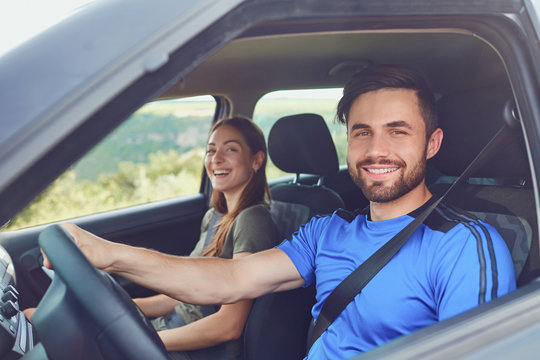 Happy Couple Traveling By Car On The Road In The Summer.