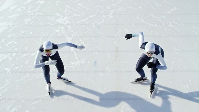 High angle view of two determined athletes standing on starting line and beginning speed skating race against each other