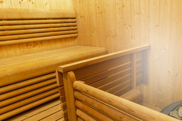 Fototapeta na wymiar Interior of Finnish sauna. Classic wooden sauna. Finnish bathroom. Wooden sauna cabin. Wooden room. Sauna steam..