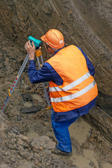 The surveyor performs geodetic survey for the cadastre