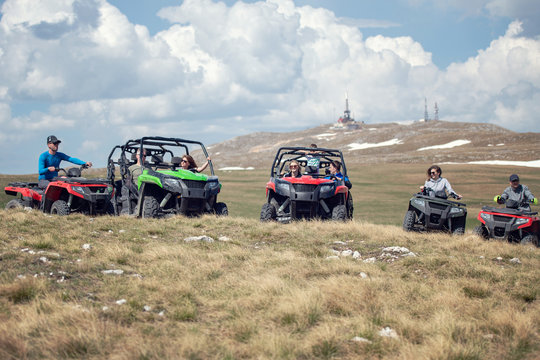 Friends Driving Off-road With Quad Bike Or ATV And UTV Vehicles