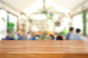 Empty of wood table top on blur of interoir coffee cafe background .For montage product display or design