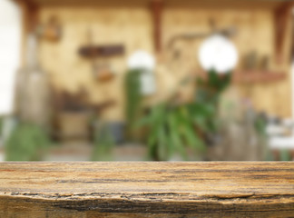 Empty wooden and table on abstract blurred background of coffee shop with shelf and window, product display, Ready for product montage.