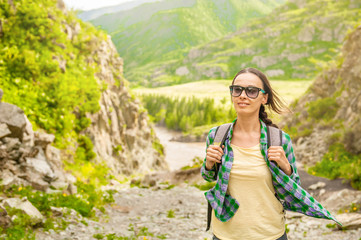 Happy smiling woman hiking in mountains enjoying outdoor activity