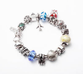 silver bracelet with charms on grey background