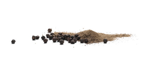 Ground black pepper powder pile, with peppercorn grains isolated on white background