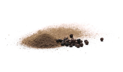 Ground black pepper powder pile, with peppercorn grains isolated on white background
