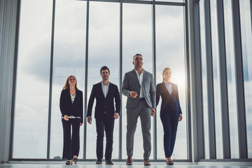 Fototapeta premium Group of business people walking in office with smart and confident, teamwork and together concept