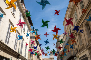 Street decorated with colorful stars in Arles, Provence. France