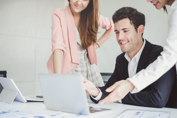 Business people discussing while meeting in office, working with laptop