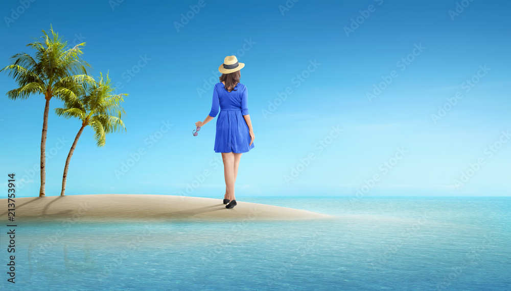 Wall mural Rear view of asian tourist woman with hat standing