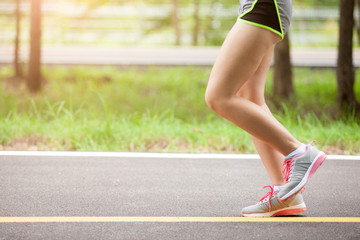 young fitness woman hiker legs at forest trail