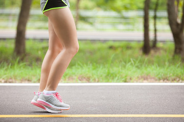 young fitness woman hiker legs at forest trail