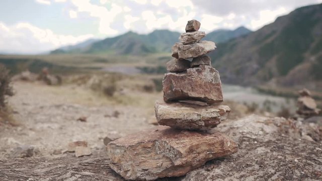 pyramid of stones against the background of mountains