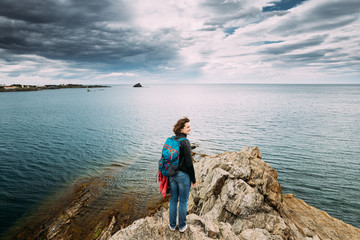 Fototapeta na wymiar Young Woman Backpacker Hiker Enjoying Sea View On Top Of A Coast