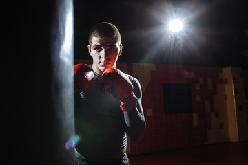 Boxer hits a speed bag in the gym, training shock