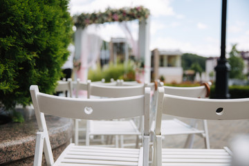 White chair with white umbrella. Wedding ceremony
