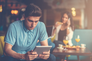 Young male using digital tablet in modern startup office