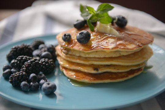 Pancakes with blackberries and blueberries on a plate