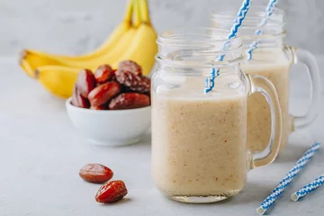 Papier Peint photo Milk-shake Smoothie aux fruits à la banane et aux dattes ou milkshake dans un bocal en verre
