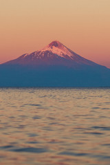 Chile. Pukon. Snow-covered volcano in sunset color