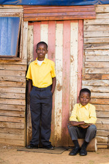 Obraz na płótnie Canvas Black boys infront of their home in the rural area