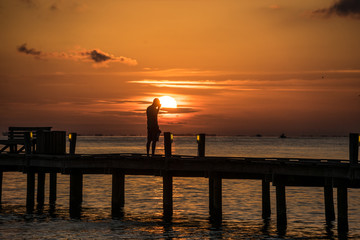 Florida Man Silhouette On Pier With Sunrise