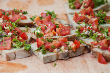 closeup of tomatoes toasts with aromatic herbs