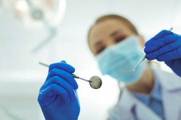 Do not worry. Silhouette of dentist that bowing head and examining teeth