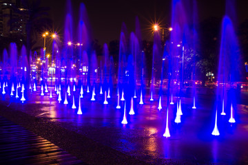 Fountain colored water show. Colorful fontain light in city