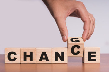 Hand hold flip wooden cube with word 