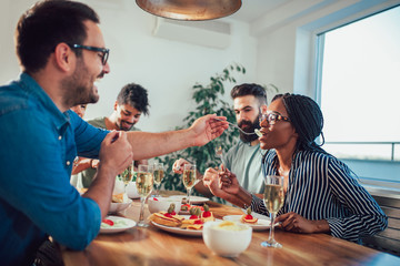 Group of multiethnic friends enjoying dinner party